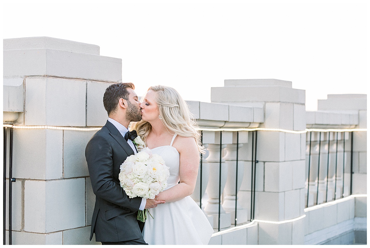 Bride and groom kissing on the roof of The Mayo Hotel| Tulsa wedding photographer| Andi Bravo Photography