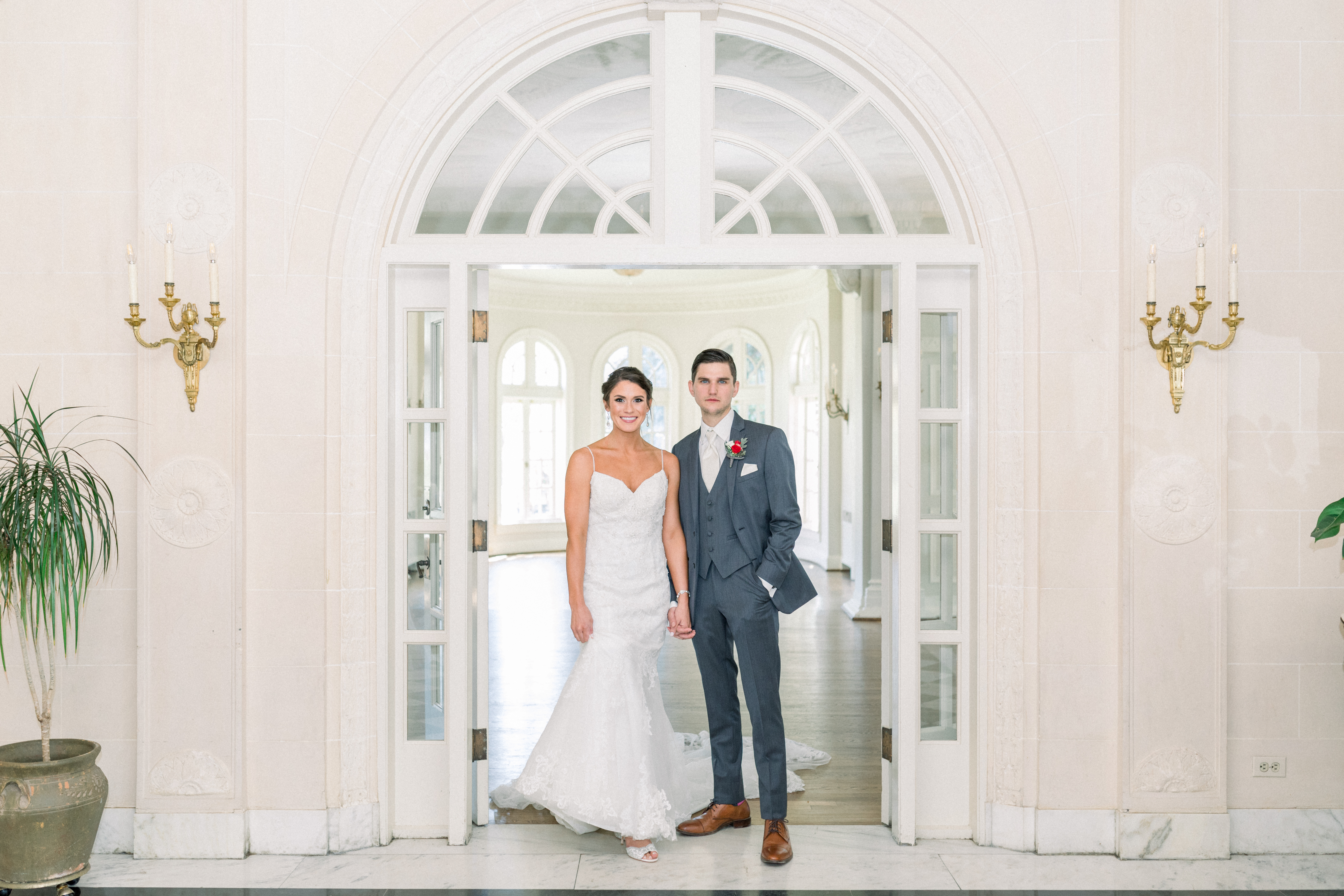 Bride and groom standing in front of doorway