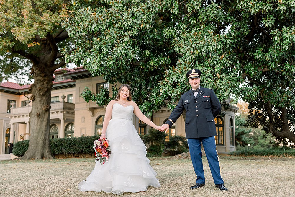 Bride and groom holding hands at Tulsa Garden Center Wedding